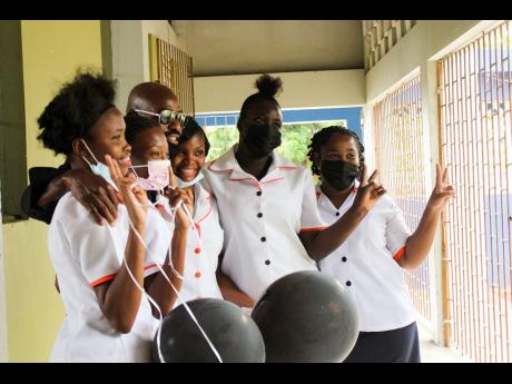 Credit: Stephanie Lyew Tivoli Gardens High School students grab a quick photo with Lt Stitchie.