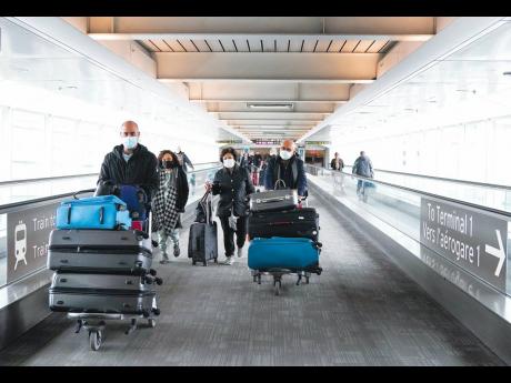 Credit: AP
People travel at Pearson International Airport in Toronto, Canada, on Friday, December 3. New travel testing and restrictions have been put in place due to the omicron variant.