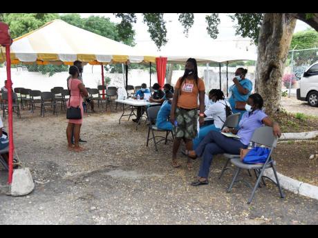 People wait for the turn to get the COVID-19 vaccine at JN+ vaccination drive and health fair on Saturday, December 4. 