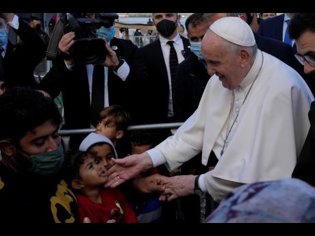 Pope Francis meets migrants during his visit at the Karatepe refugee camp, on the northeastern Aegean island of Lesbos, Greece.