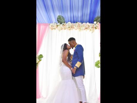 Right: Latoya and Rudolph seal their union with a kiss.