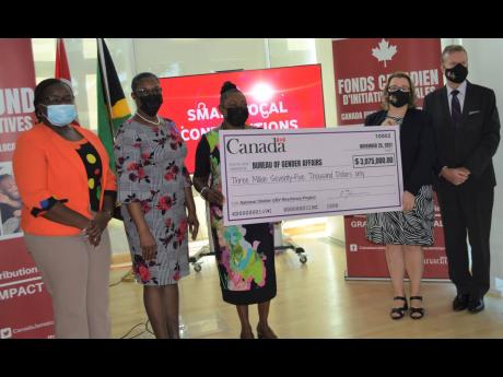 Minister of Culture, Gender, Entertainment and Sport Olivia Grange (third left) and Canadian High Commissioner Emina Tudakovic hold a symbolic cheque of CDN$25,000, representing Canada’s support for the National Shelter Programme. The presentation was ma