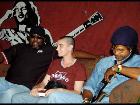 Rhythm Twins Sly Dunbar (right) and Robbie Shakespeare (left) sit with Sinead O’Connor at the launch of her album ‘Throw Down Your Arms’, held at the Liguanea Club in August 2005.