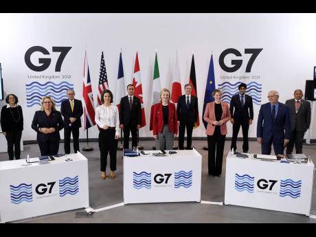 G-7 foreign and development ministers pose for a group photo in Liverpool, England, yesterday.