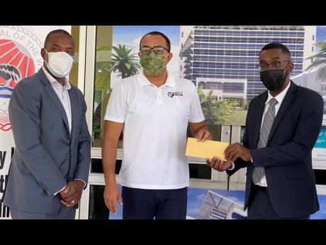 Minister of Health and Wellness Dr Christopher Tufton (centre) hands over a cheque to Kevin Allen (right), CEO of the University Hospital of the West Indies (UHWI), to go towards plans for a six-storey facility to boost service delivery. Sharing in the mom