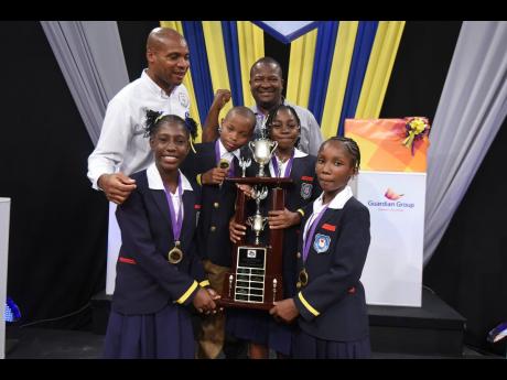 Principal Collington Powell (left) and Coach Zavier Clarke celebrate with the victorious Friendship Primary team after they defeated Creative Kids Learning Academy 25-16 in the final of TVJ’s Junior Schools’ Challenge Quiz Competition on Thursday. The 