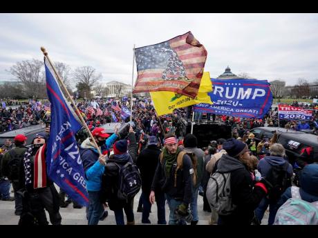 Insurrectionists loyal to President Donald Trump swarm the Capitol, January 6, in Washington. 