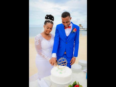 Credit: Contributed The McFarlanes happily engage in the traditional cutting of the wedding cake provided by Iberostar Rose Hall Beach Resort.