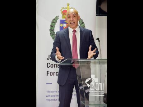 Major General Antony Anderson, the commissioner of police, is animated as he delivers the keynote address during a meeting of the Kiwanis Club of St Andrew held at Christar Villas Hotel Monday evening. 