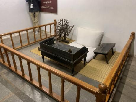 Credit: Judana Murphy Gandhi’s room in the heart of the Ashram with a spinning wheel and two writing desks on display.