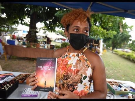 Brianna Leigh-An Johnson displays her book.