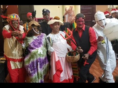 Sophia Walsh-Newman (carrying the hamper basket) with a group of other Jonkonnu masqueraders at a Grand Market in New York.