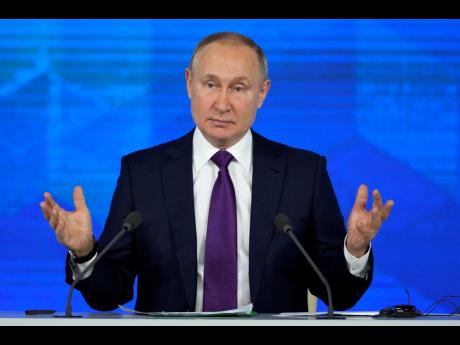 Russian President Vladimir Putin gestures during his annual news conference in Moscow, Russia, yesterday.