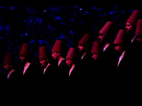 7. Whirling dervishes of the Mevlevi order perform during a Sheb-i Arus ceremony in Konya, central Turkey.