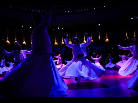 Whirling dervishes of the Mevlevi order perform during a Sheb-i Arus ceremony in Konya, central Turkey.