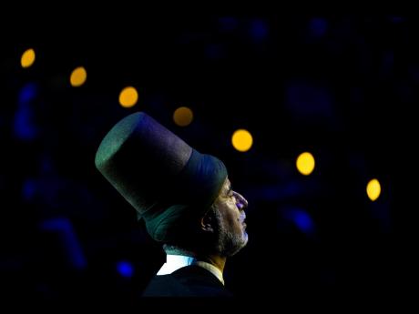 5. Fahri Ozcakil, sheikh of the Mevlevi order of whirling dervishes offers his prayers during a Sheb-i Arus ceremony, in Konya, central Turkey.