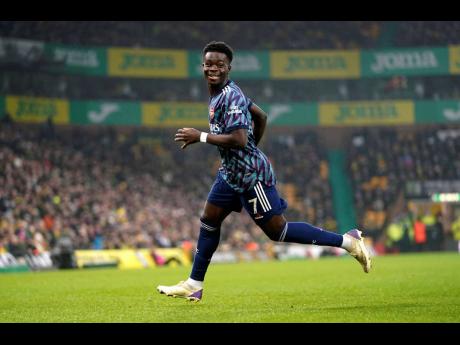 Arsenal’s Bukayo Saka celebrates after scoring during the English Premier League match between Norwich City and Arsenal at Carrow Stadium, Norwich, England yesterday.