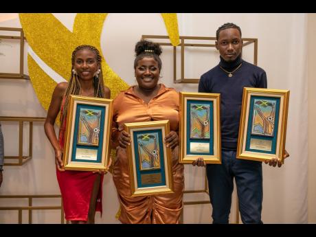 Credit: Contributed Popular social media entrepreneur Donna Gowe (centre) was among the 50 Sagicor Community Heroes. She is joined by awardees Renea Bromfield (left) and Chaz Pinnock, who is from a family of awardees. Not only was Pinnock presented with his own award, so was