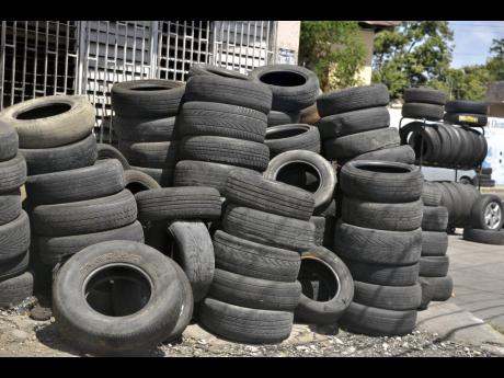 Used tyres pile up by the side of the road along Spanish Town and Waltham Park roads in Kingston.