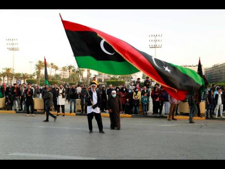 Libyans celebrate the 70th anniversary of their country’s independence, despite widespread disappointment over the postponement of the presidential elections, which were scheduled to take place on the same day, in Martyrs’ Square, Tripoli, Libya, Frida