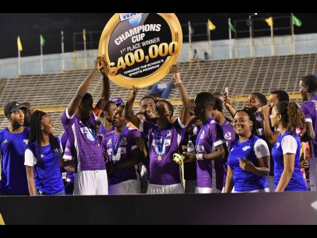 Kingston College players celebrate winning the Champions Cup after they defeated Clarendon College 1-0 in the final at the National Stadium on Saturday, November 23, 2019.