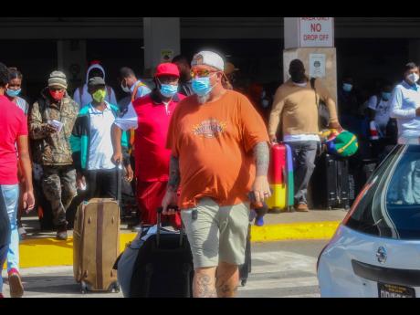 Visitors arrive at Sangster International Airport in Montego Bay, St James, on December 15, the beginning of the winter tourist season.