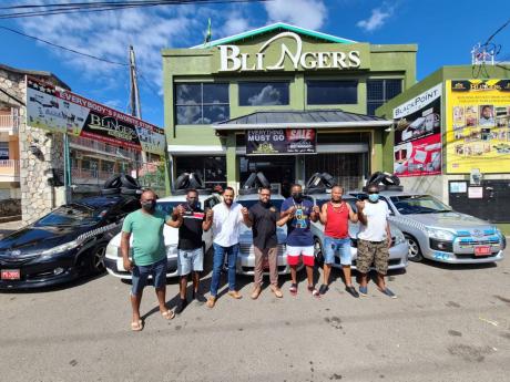 Mark Pai (third, left) with taxi drivers who he gifted with new tyres recently. 