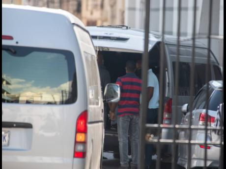 
Police officers arrive at the Supreme Court with Mario Antonio Palacios Palacios on Friday. The court has ordered that the Colombian be released from custody tomorrow and placed on a flight to his homeland.