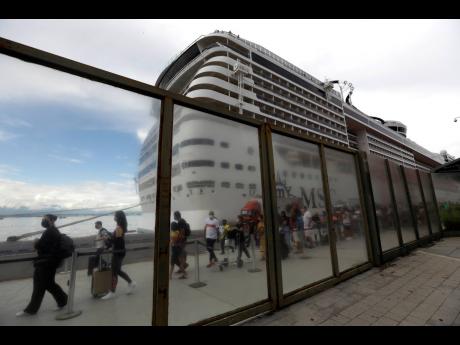 Passengers disembark from the cruise ship ‘MSC Preziosa’, in the Port Area of Rio de Janeiro, Brazil, Sunday, January 2, 2022, after Brazil’s Sanitary Agency confirmed more cases of COVID-19 on board.