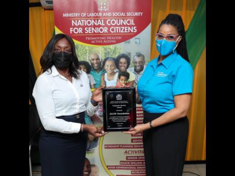 Kayon Mitchell (right), executive director, Flow Foundation, accepts the Corporate Service Award from Casandra Morrison, executive director, National Council for Senior Citizens.