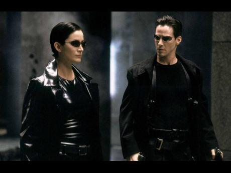 Keanu Reeves and Carrie-Anne Moss reprise their iconic roles as Trinity and Neo in ‘The Matrix Resurrections’.