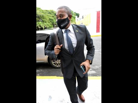 Newly minted Minister without Portfolio Floyd Green strolls towards Gordon House Tuesday for his first sitting of the House of Representatives after his return to the Cabinet. Green has been tasked with coordinating the roll-out of the National Identificat