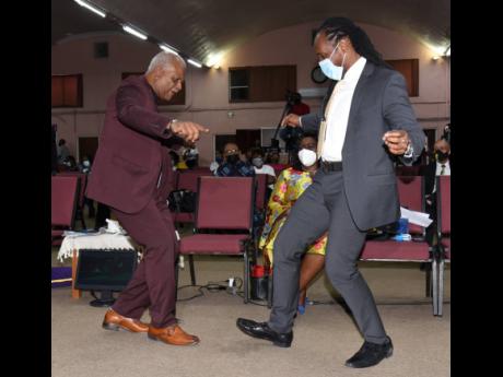 The Reverend Merrick ‘Al’ Miller (left), pastor of Fellowship Tabernacle, and Alando Terrelonge, state minister in the Ministry of Culture, Gender, Entertainment and Sport, show off their dance moves during the 2021 Reggae Month church service held at 