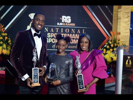 Credit: Hansle Parchment, RJRGLEANER Sportsman of the Year 2021; Tina Clayton, VM YOUTH Award recipient; and Elaine Thompson Herah, RJRGLEANER Sportswoman of the Year 2021, are all smiles as they show off their well-deserved trophies.