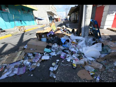Uncollected garbage pile up along Princess Street, downtown Kingston