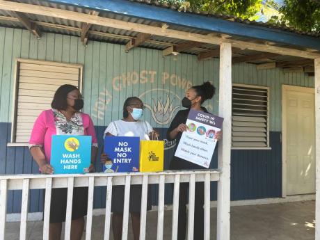 Danah Cameron (right), Jamaica Broilers Group public relations manager shares a quick chat with Holy Ghost Power Early Childhood Institution principal, Donna Brown (left) and teacher, Jodi-Kay Toomer about how their new COVID-19 protocol signs and other do