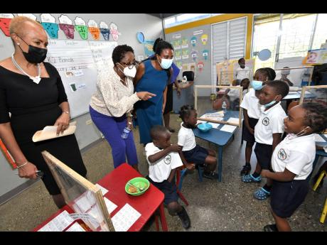 From left: Fayval Williams, minister of education and youth; Dr Angela Brown Burke, opposition spokesperson on education; and Trisha Williams-Singh, chairman, Early Childhood Commission, interact with students at the launch of the Year of Early Childhood D