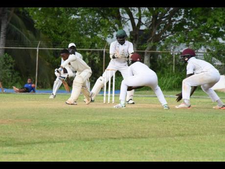 File
Rajay Simpson (left) of St Elizabeth Technical High (STETHS) plays a defensive stroke during the 2018 ISSA Spaulding Cup playoff against Innswood High at the STETHS Sports Complex.