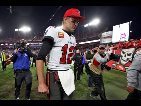 Tampa Bay Buccaneers quarterback Tom Brady (12) reacts as he leaves the field after the team lost to the Los Angeles Rams during an NFL divisional round playoff football game Sunday, Jan. 23, 2022, in Tampa, Fla. 
