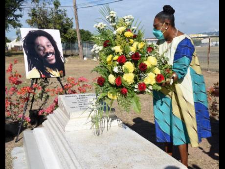 Credit: Ian Allen Minister of Culture, Gender, Entertainment and Sport Olivia Grange lays a wreath at the grave of legendary reggae singer Dennis Brown on what would have been his 65th birthday on Tuesday.