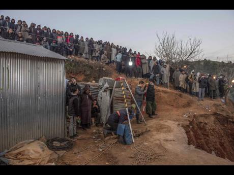 Residents watch in concern as civil defence and local authorities dig in a hill on Thursday as they attempt to rescue a five-year-old boy who fell into a hole near the town of Bab Berred near Chefchaouen, Morocco. 