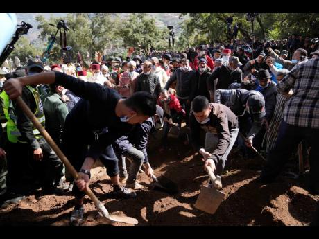 Workers cover the grave dug for five-year-old Rayan during his funeral on Monday after his body was retrieved from a deep well, in the village of Ighran in Morocco’s Chefchaouen province.