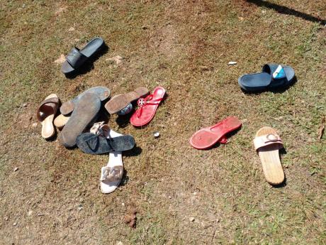 Credit: Photo by Hopeton Bucknor Frightened partygoers left their shoes behind as they scampered for safety.