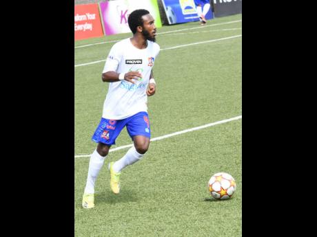 Credit: Rudolph Brown/Photographer Dunbeholden midfielder Demario Phyllips dribbles during his team’s Jamaica Premier League clash against Molynes United at the UWI-JFF Captain Horace Burrell Centre of Excellence yesterday. Phyllips scored the loan goal of the game.