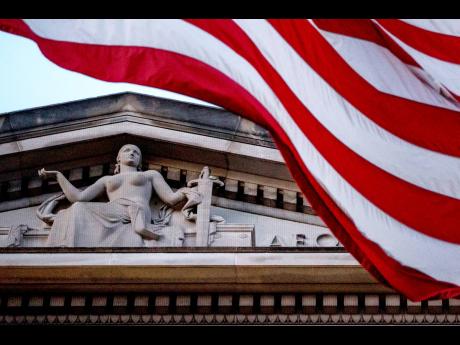 Credit: AP An American flag flies outside the US Department of Justice in Washington on March 22, 2019.