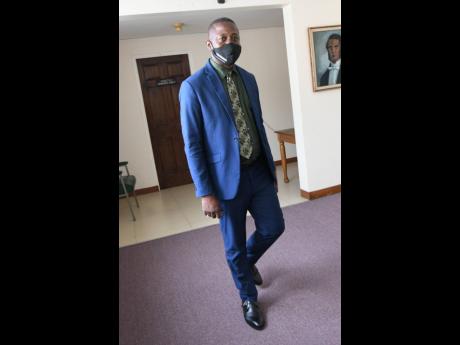 George Wright is seen at the Parliament building on Thursday. His decision to walk with the Opposition PNP stoked outrage among its members.