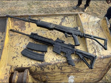 
AK-47 and M16 rifles – two of the eight guns found at the Stadium East field in St Andrew in January.