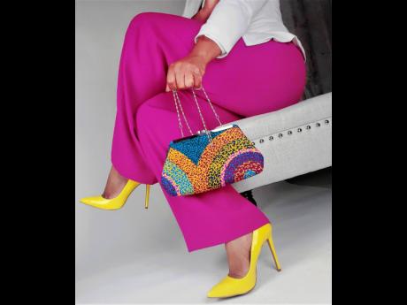 Add a little colour to your accessories collection with this vibrant clutch bag with a Flinstone jazz clasp.