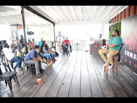 Romeich Major engages the males of the Dragon ‘Be The One’ campaign session at his headquarters, on Campbell’s Blvd, 
St Andrew.
