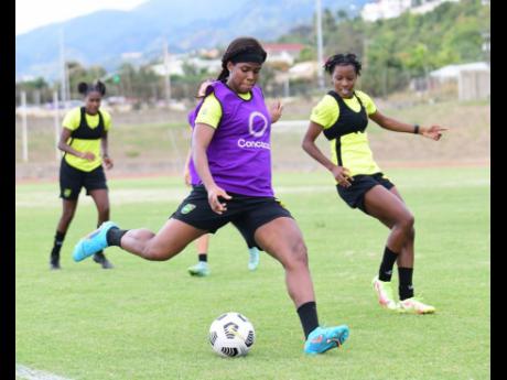 Credit: Gladstone Taylor Reggae Girlz Khadija Shaw (left) and Jody Brown in action during a training session session at Stadium East yesterday ahead of their Concacaf World Cup qualifier against Bermuda tomorrow at the National Stadium.